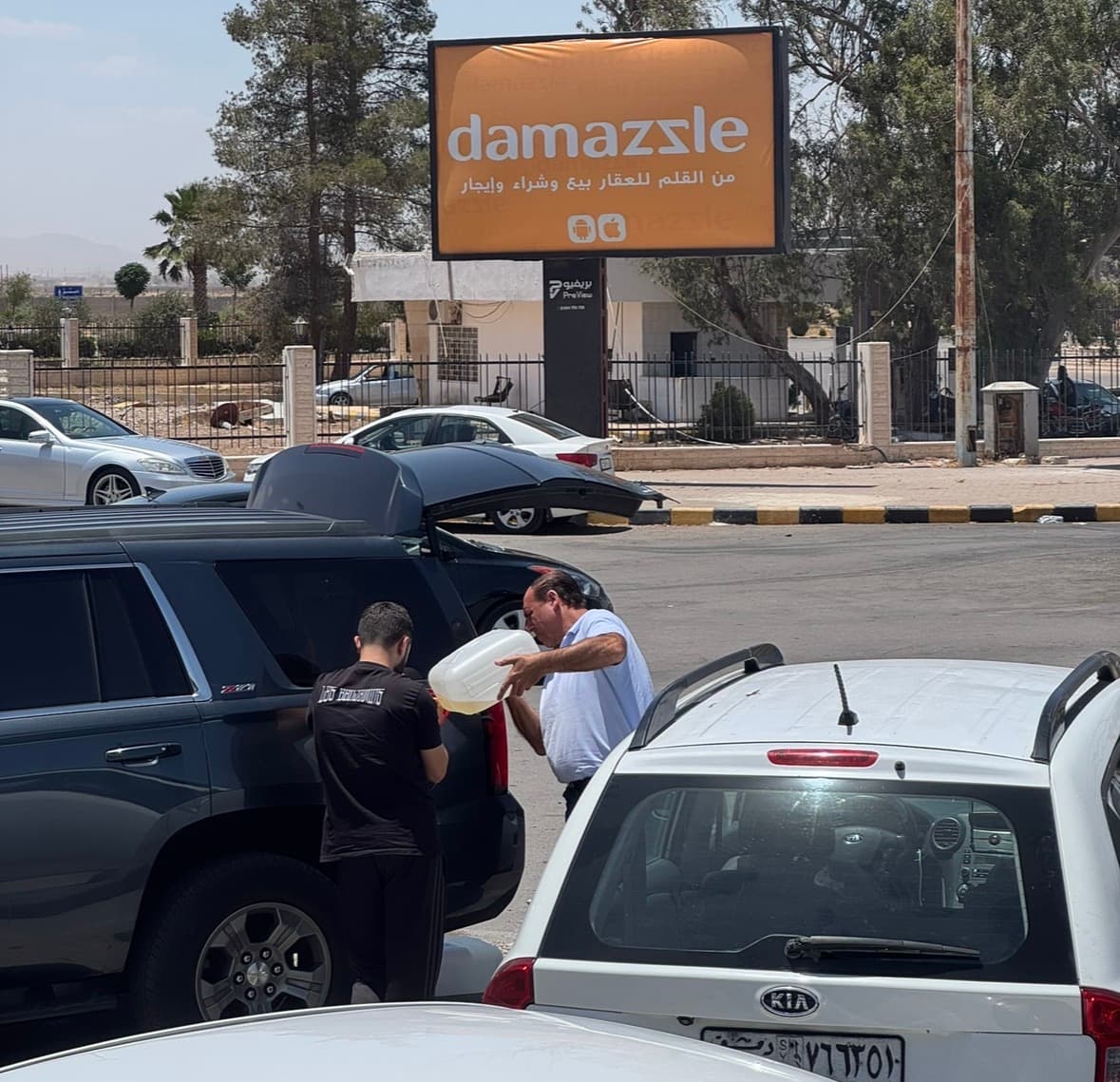 A motorist refuels a vehicle from a jerrycan in Damascus. © Aladdin Aljian