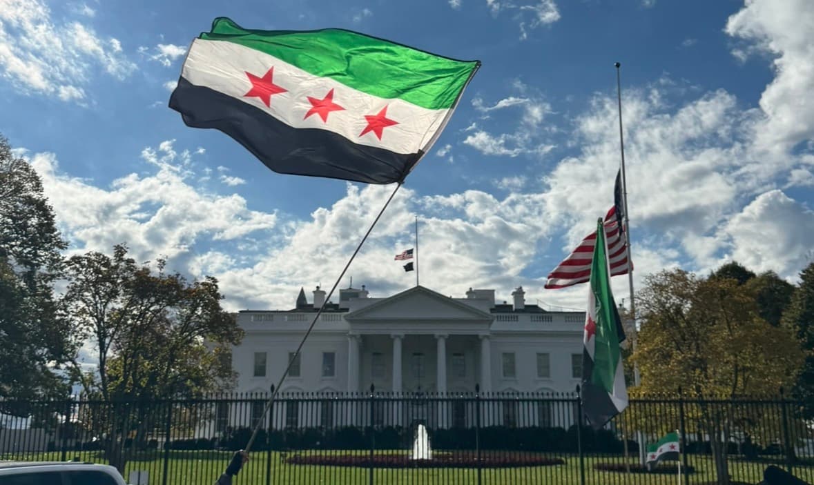 Syrian flags outside the White House during Ahmed al-Sharaa’s visit to Washington in November 2025.